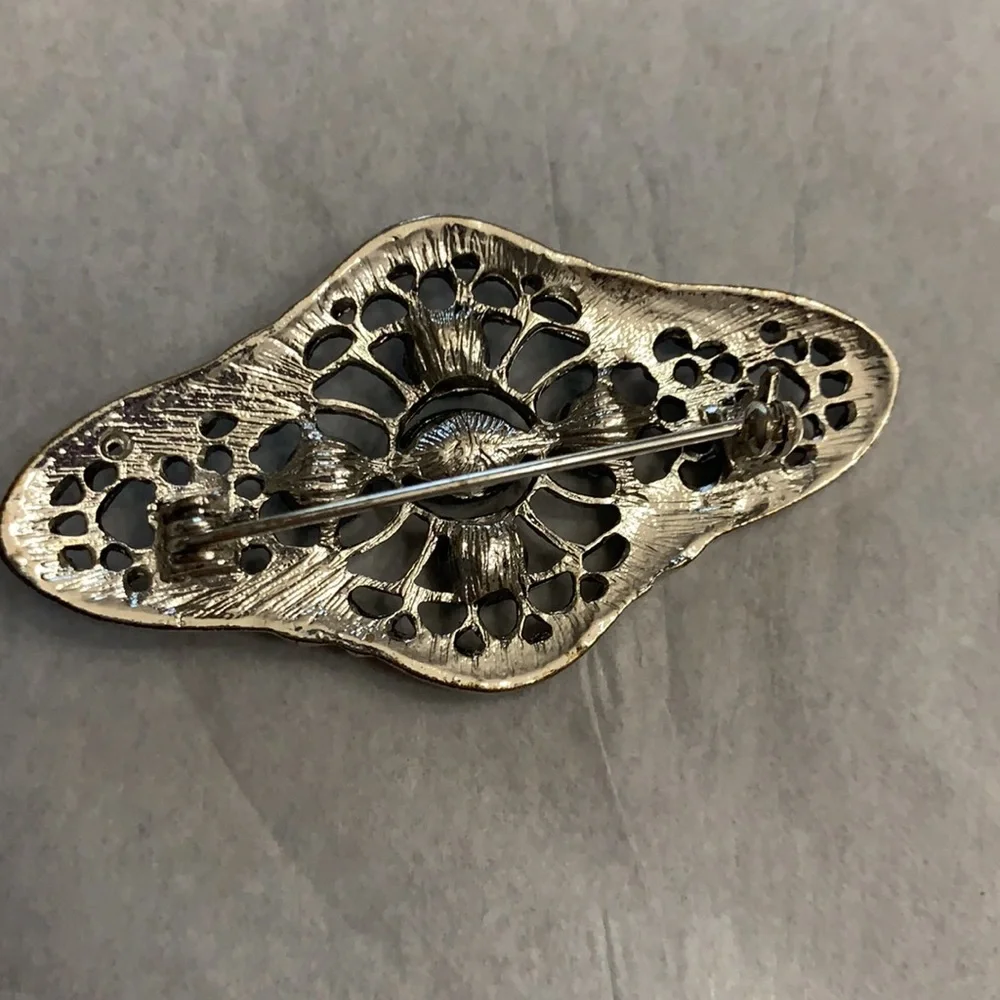 Silver and black brooch